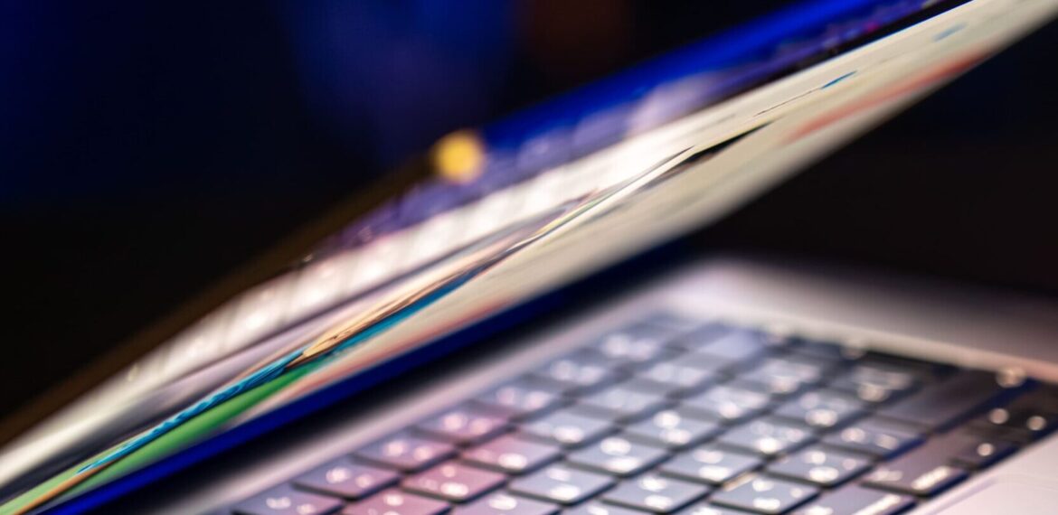 laptop-computer-with-halfopen-screen-dark-background-copy-space (1) (1)