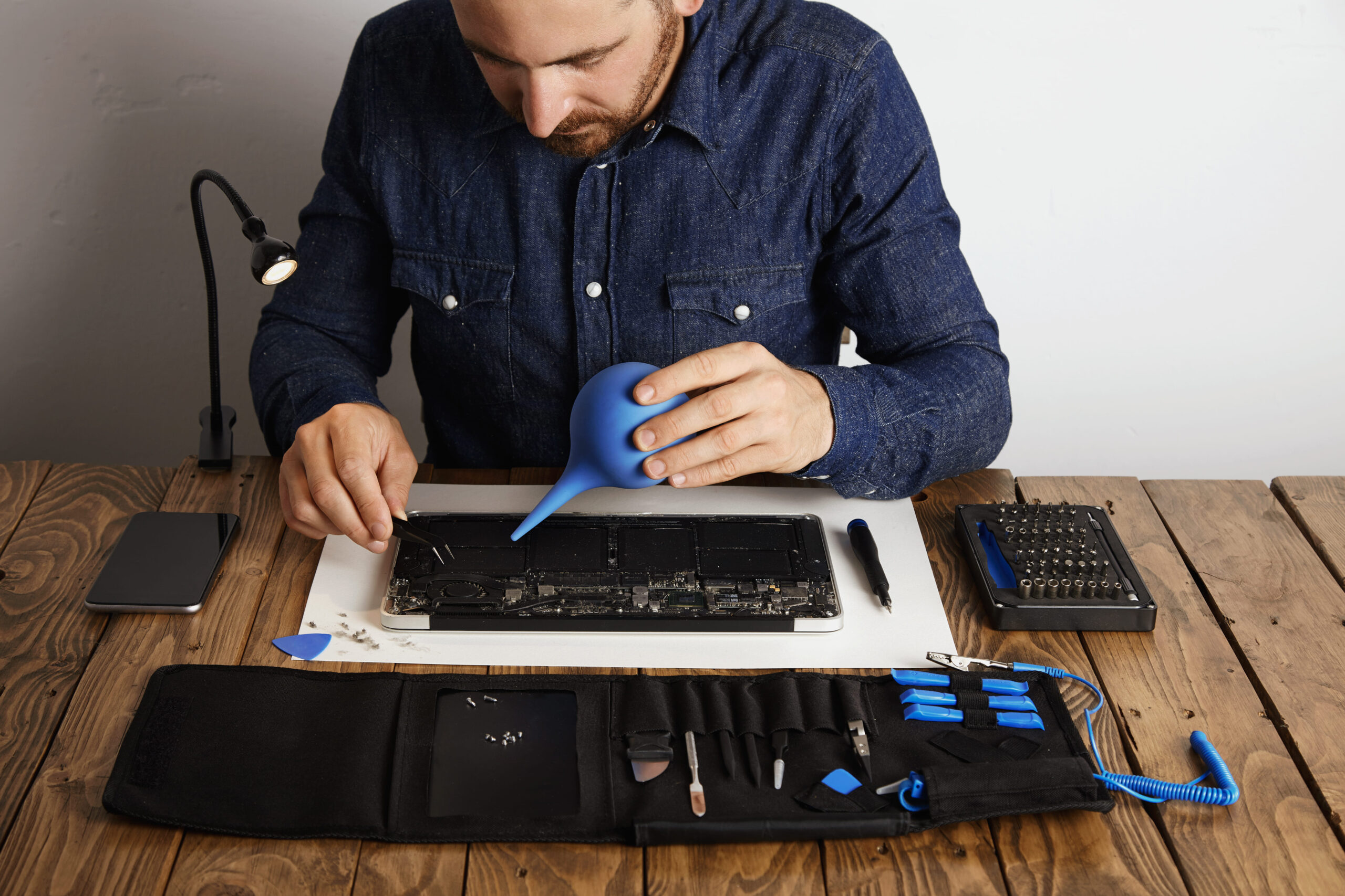 professional-is-working-his-lab-repair-clean-computer-laptop-toolkit-box-with-specific-instruments-near